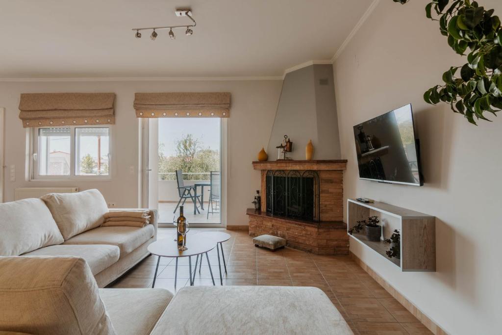 a living room with a couch and a fireplace at Elia House Nafplio in Nafplio