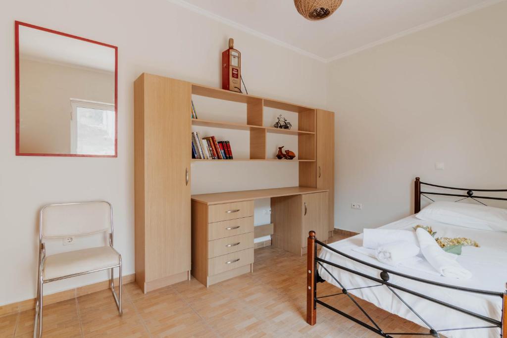 a bedroom with a bed and a mirror and a desk at Elia House Nafplio in Nafplio