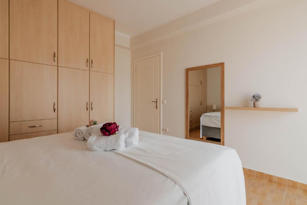 a bedroom with a white bed with towels on it at Elia House Nafplio in Nafplio