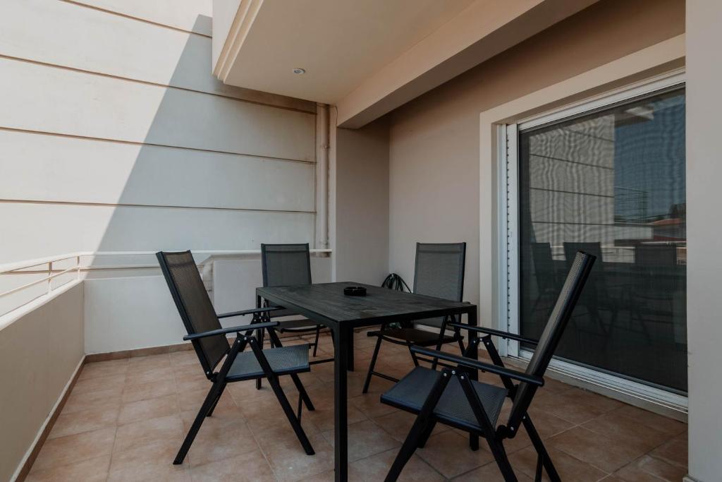 a table and chairs in a room with a window at Elia House Nafplio in Nafplio