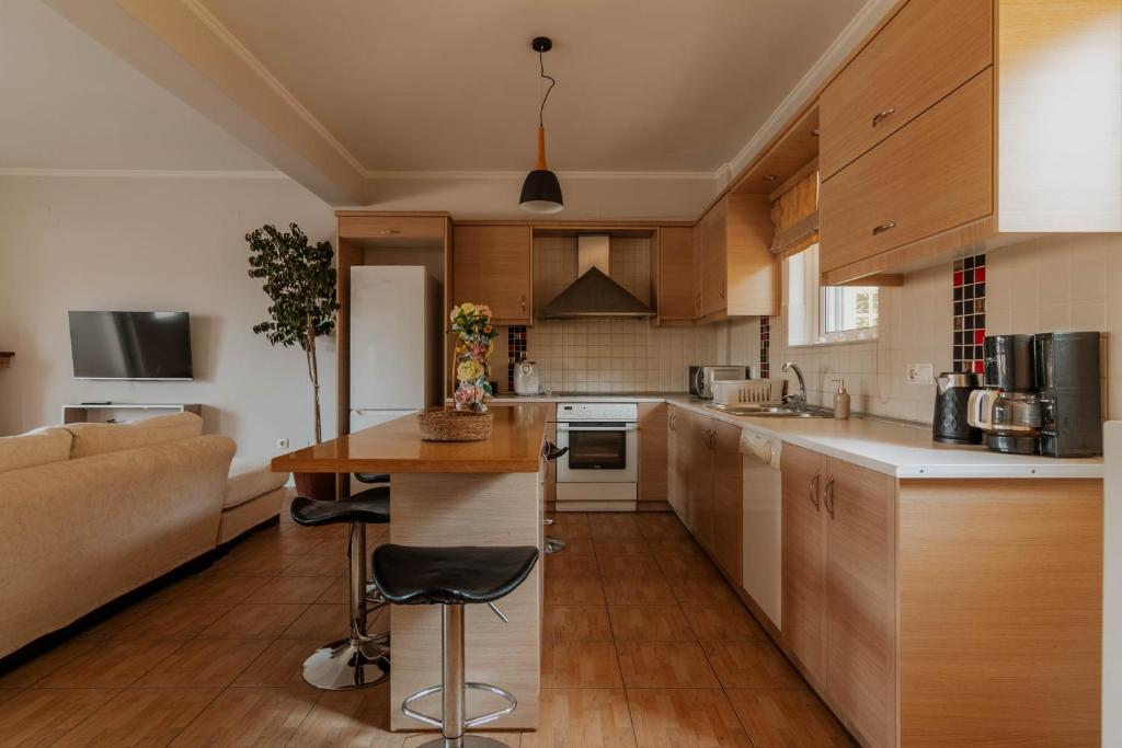 a kitchen with a couch and a table in a room at Elia House Nafplio in Nafplio