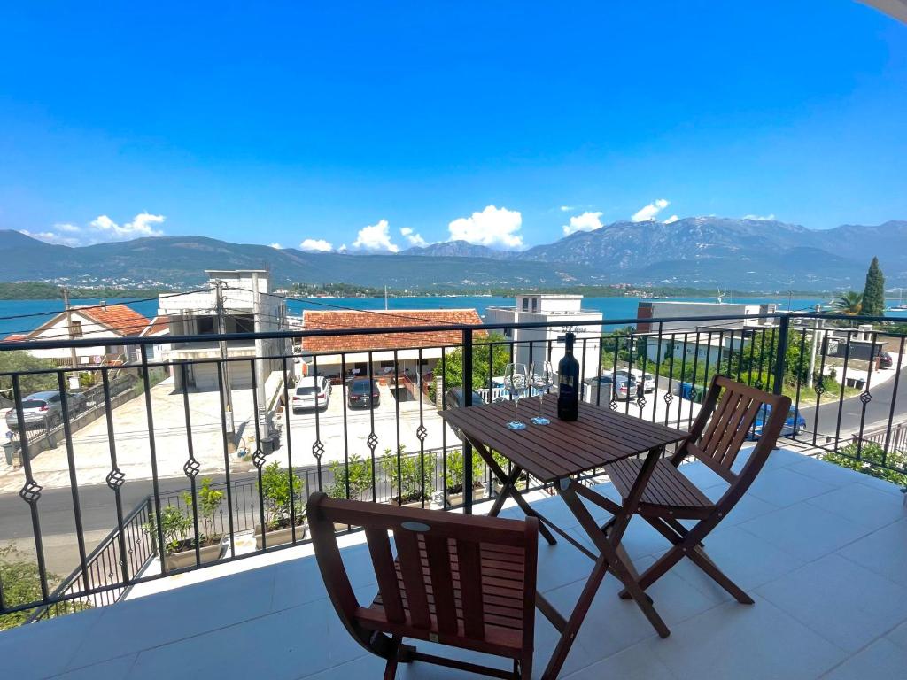 a table and two chairs on a balcony with a view at Villa Regulus in Tivat