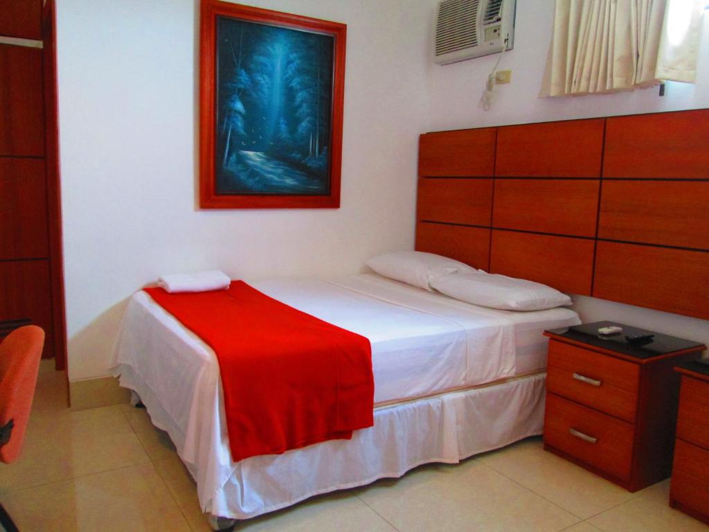 Postel nebo postele na pokoji v ubytování Hotel Apart Guayaquil Aeropuerto