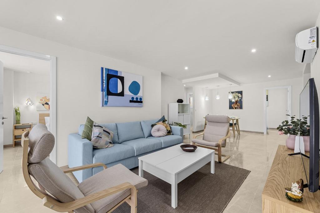 アレシーフェにあるCasahost Casa Albaの青いソファと椅子のあるリビングルーム