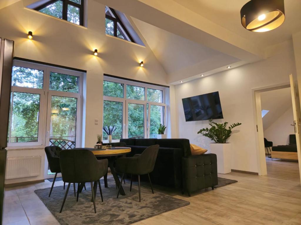 a living room with a couch and a table at Wyjątkowy Apartament w Miliczu in Milicz