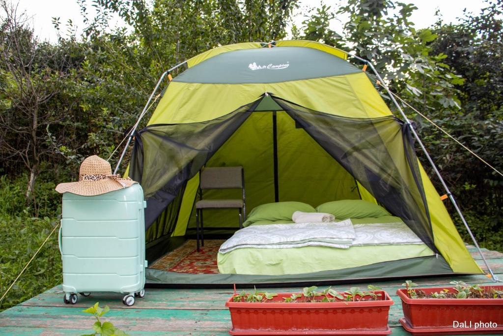 a tent with a bed and a chair in it at Тереза кемпинг in Alaverdi