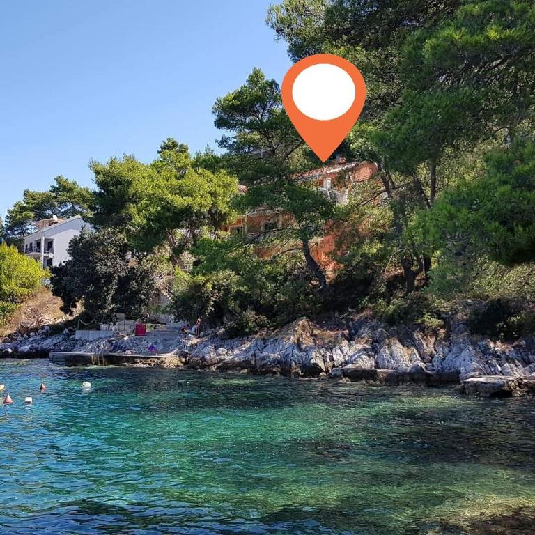 a red object is flying over a body of water at Apartments Dalibor in Brna