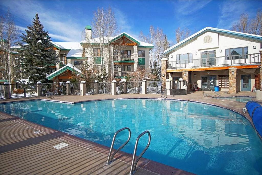 a large swimming pool in front of a house at Heated Pool, Private Washer & Dryer, Ski In, Ski Out, Just Remodeled in Steamboat Springs
