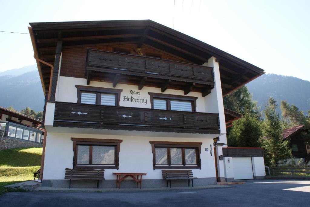 a building with a balcony on top of it at Ferienhaus Waldesruh in Sautens