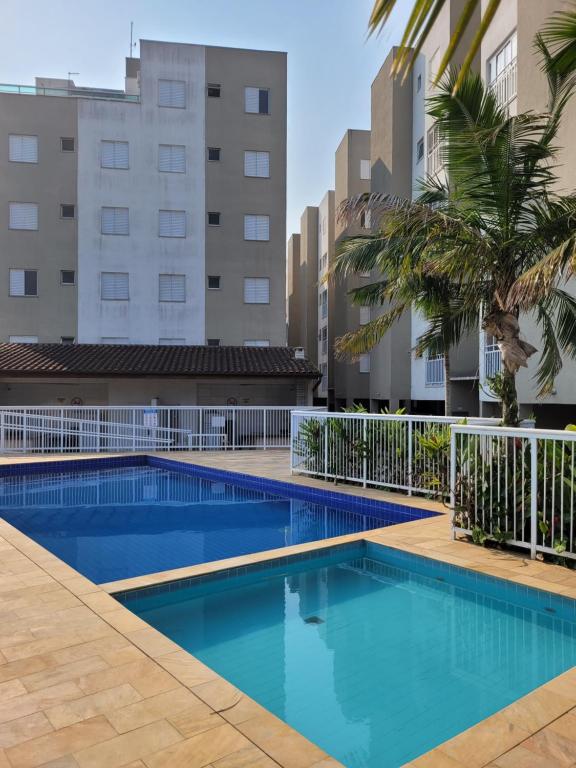 an image of a swimming pool with buildings in the background at Apartamentos Gratitude in Ubatuba
