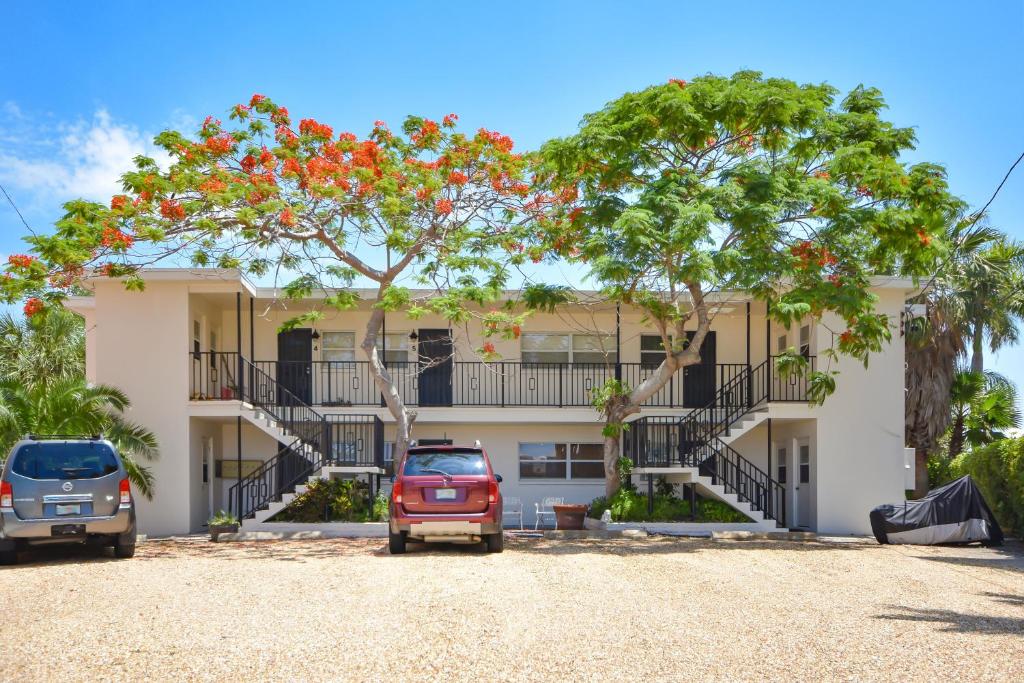a building with cars parked in front of it at Bay Watch #6 - Weekly Beach Rental in Clearwater Beach