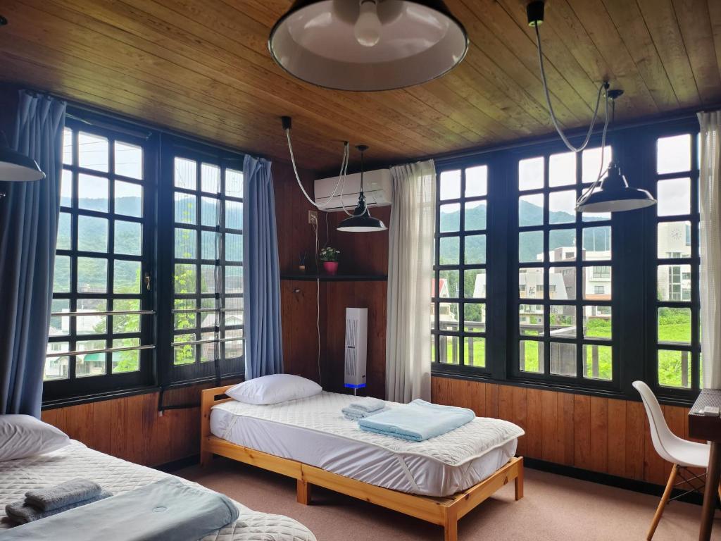 Postel nebo postele na pokoji v ubytování ロッヂノエル