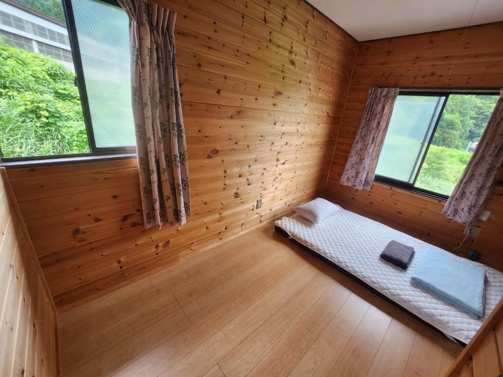 Postel nebo postele na pokoji v ubytování ロッヂノエル