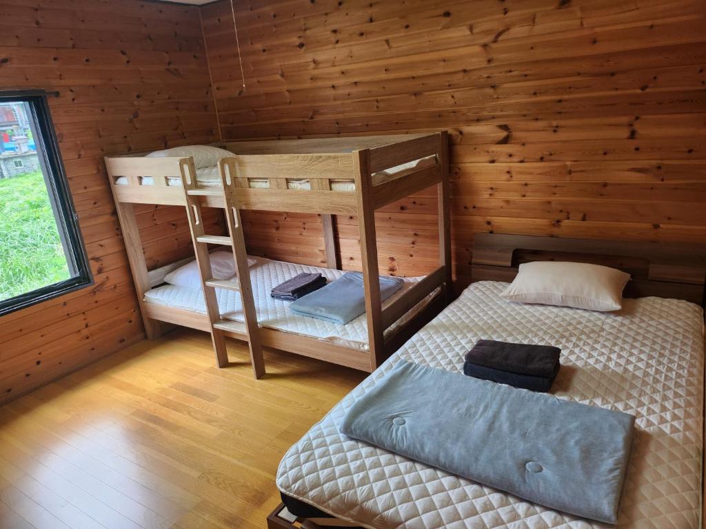Postel nebo postele na pokoji v ubytování ロッヂノエル