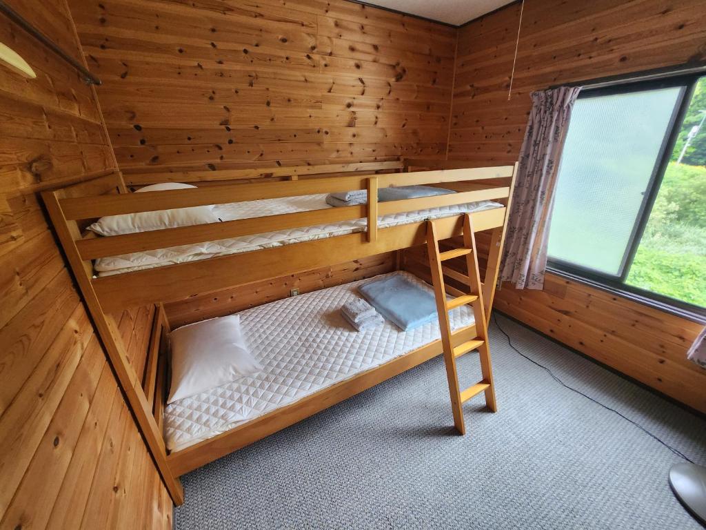 Postel nebo postele na pokoji v ubytování ロッヂノエル