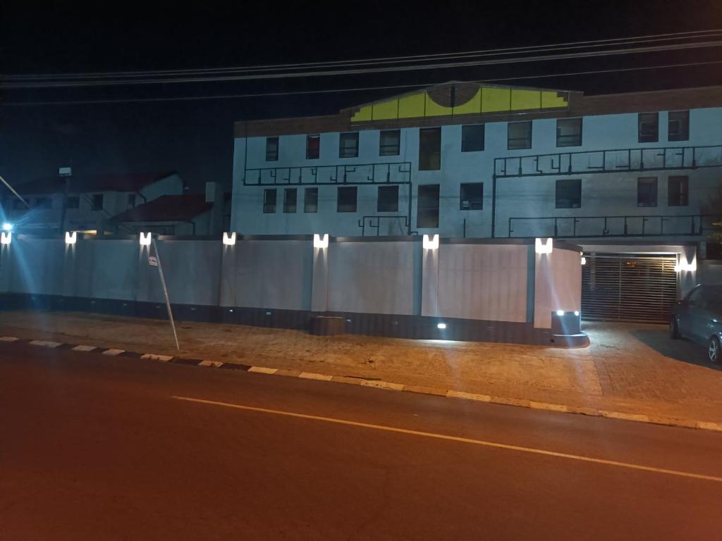 a building on the side of a street at night at Glenanda Hotel in Johannesburg