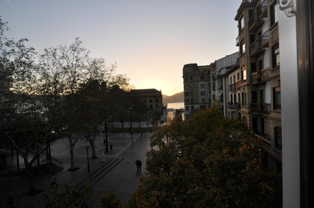 a person walking down a street in a city at Pension Alameda in San Sebastián