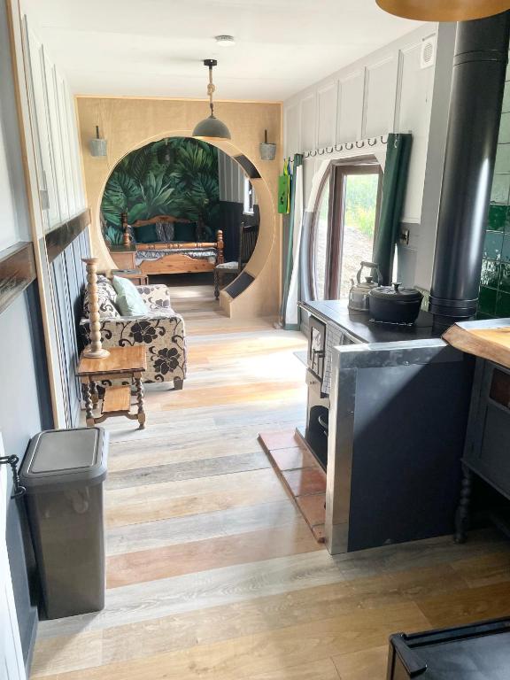 a living room with a kitchen and a living room with a couch at Acorn Cabin in Welshpool