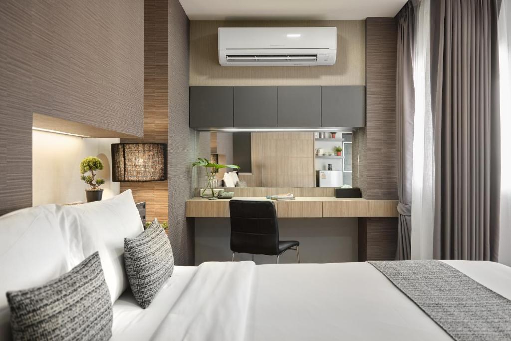 A close view of the in-room desk and kitchenette beside the bed.