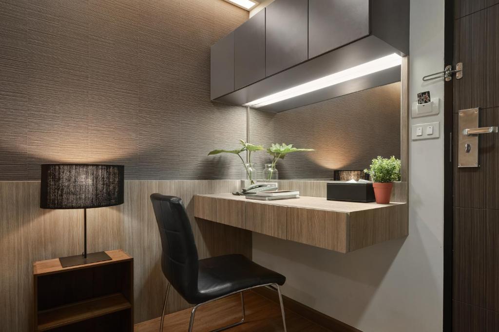 A built-in work desk with a single chair sits beside the entry door.
