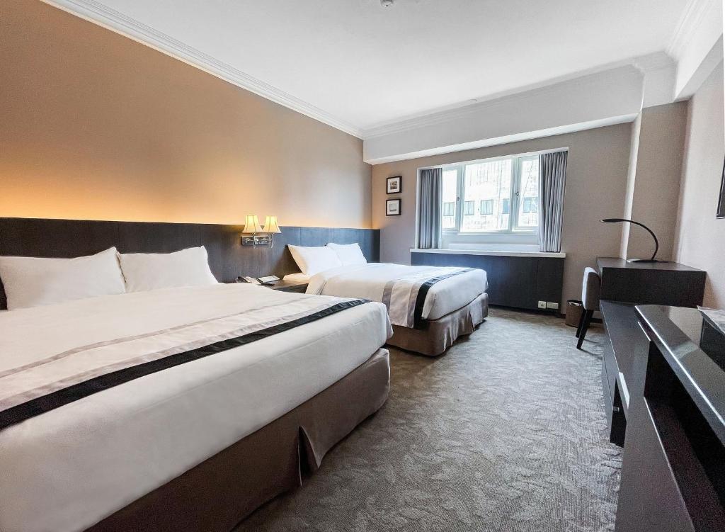 Postel nebo postele na pokoji v ubytování Guide Hotel Kaohsiung Liuhe