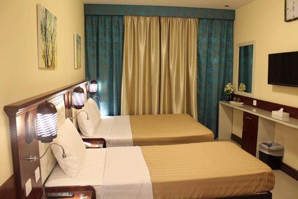 Postel nebo postele na pokoji v ubytování Mariana Hotel