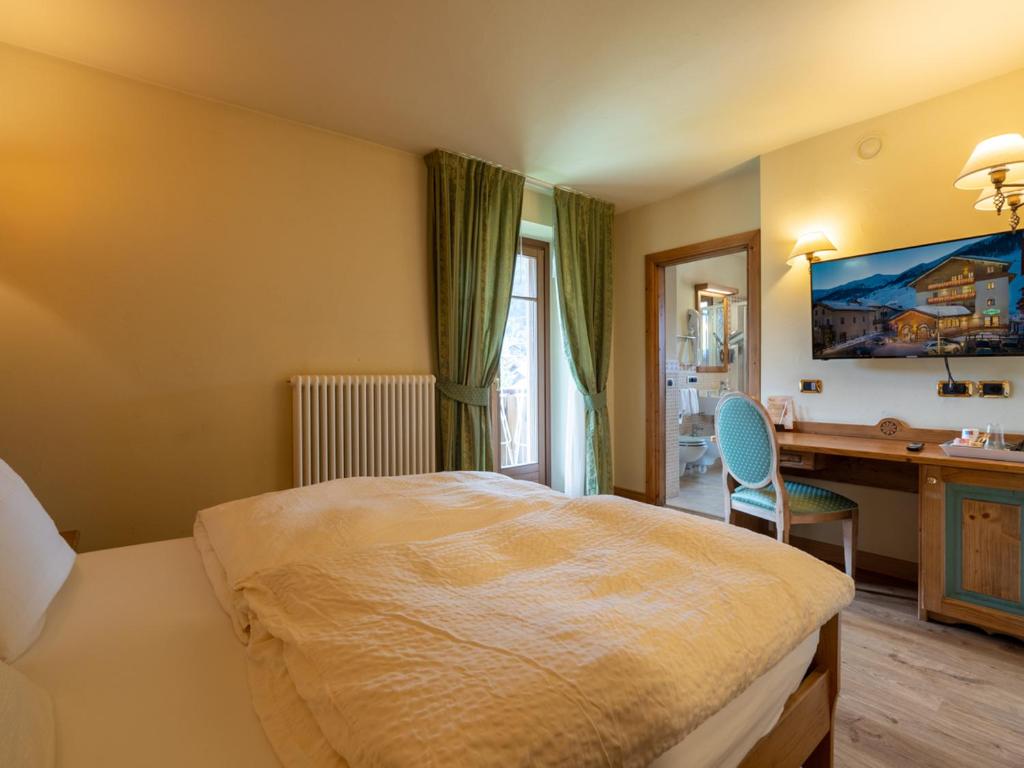 Postel nebo postele na pokoji v ubytování Hotel Cervo
