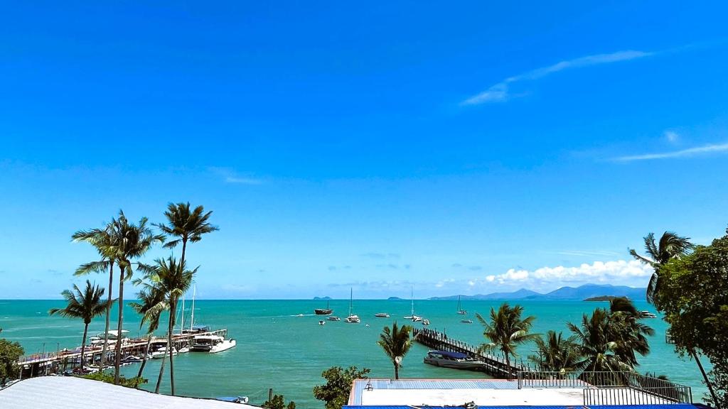 a view of a beach with boats in the water at Rockstar Beach Apartments in Bang Rak Beach