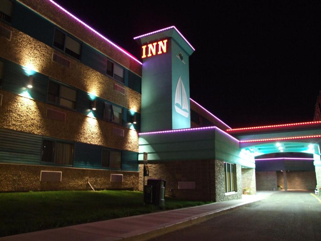 a building with a neon sign on it at night at Lakeland Inn Hotel in Cold Lake