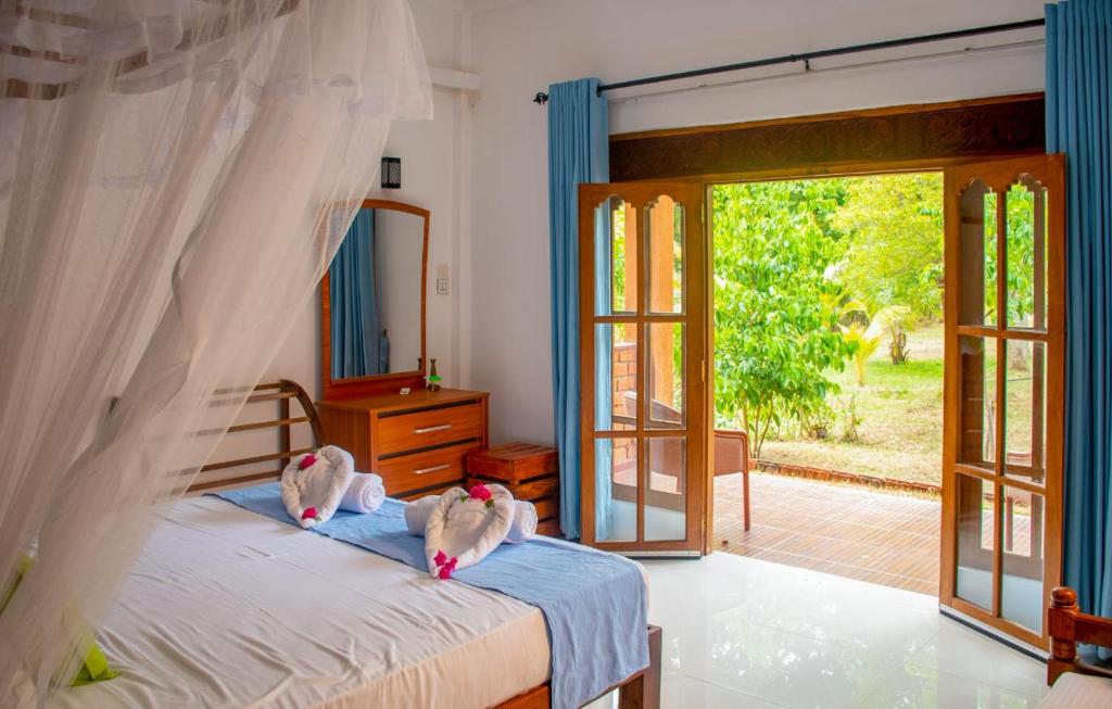 Postel nebo postele na pokoji v ubytování Sigiriya Cottage