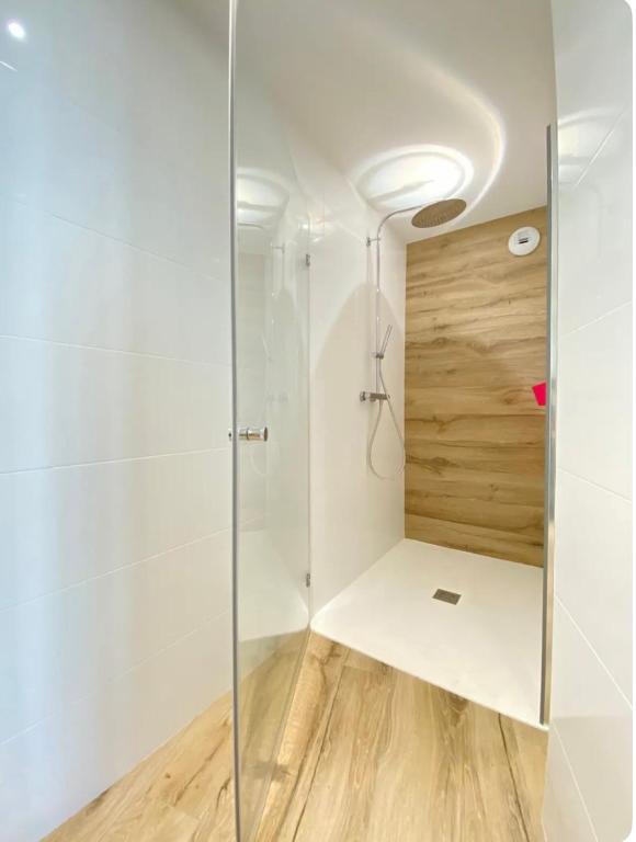 une salle de bain avec une douche avec une porte vitrée dans l'établissement Ty COSY, à Ploemeur