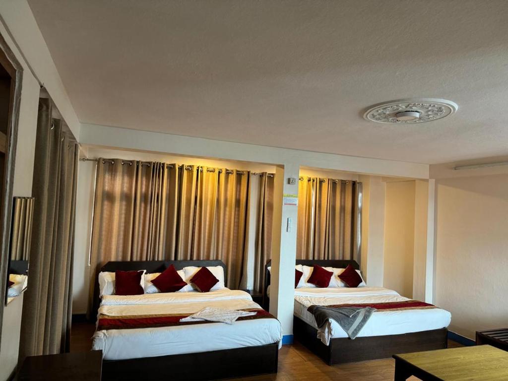 Postel nebo postele na pokoji v ubytování Hotel Silver Jubilee