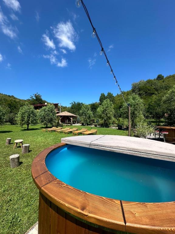 a swimming pool with a wooden fence around it at Country Chalet in Praid