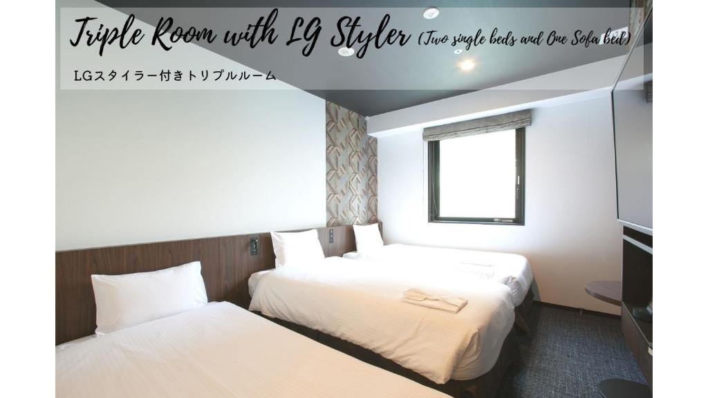a hotel room with two beds and a window at Henn na Hotel Tokyo Akasaka in Tokyo