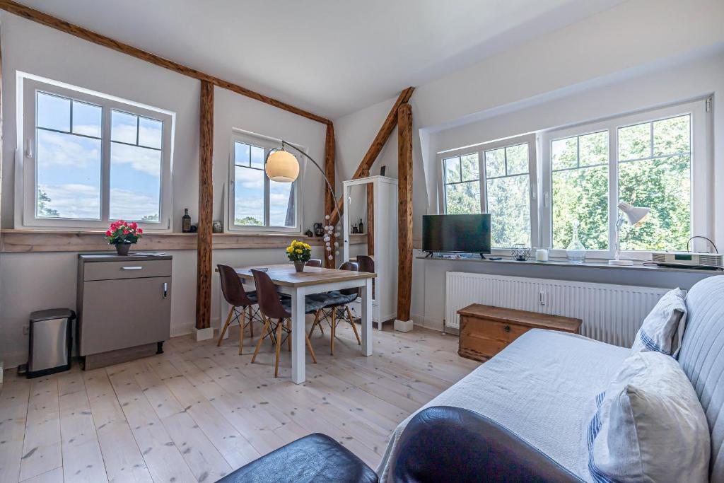 a living room with a bed and a table at fewo1846 - Am Walfischstein - strandnahe 2-Zimmer-Wohnung im 1 OG in eleganter Jugendstilvilla in Westerholz