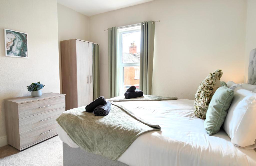 a bedroom with a bed with teddy bears on it at Douglas House, near Hospital, attractive and comfy 2 bedroom House with enclosed yard to rear in Carlisle