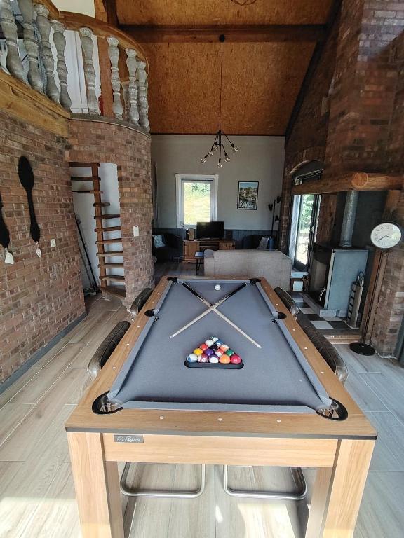 a pool table in the middle of a room at La Sérénade in La-Roche-en-Ardenne