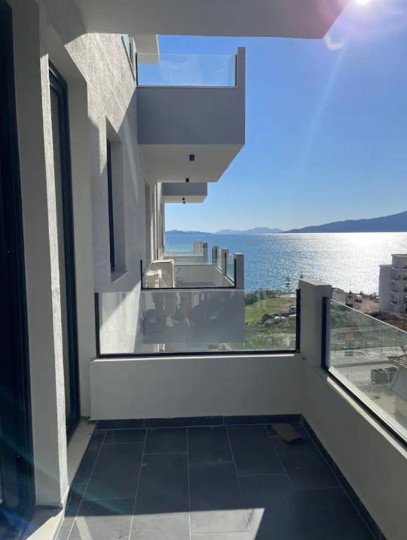 a balcony with a view of the water at Dioneida Apartments in Sarandë