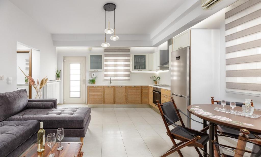 a living room with a couch and a table at Historical Old Town Luxury Apartment in Ierápetra