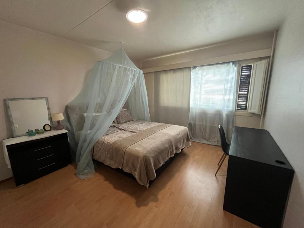 a bedroom with a bed with a canopy at Spacious Two Room Apartment in Espoo in Espoo