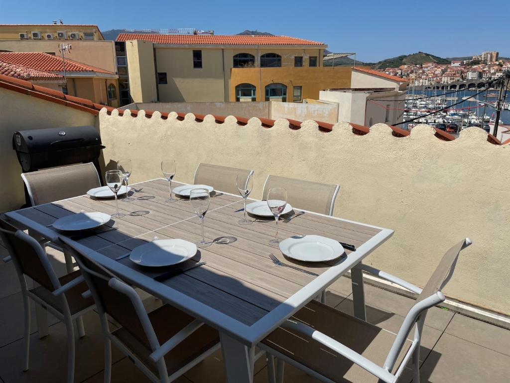 une table bleue et des chaises sur un balcon dans l'établissement Cote Vermeille - Maison climatisée avec Wifi, à Banyuls-sur-Mer