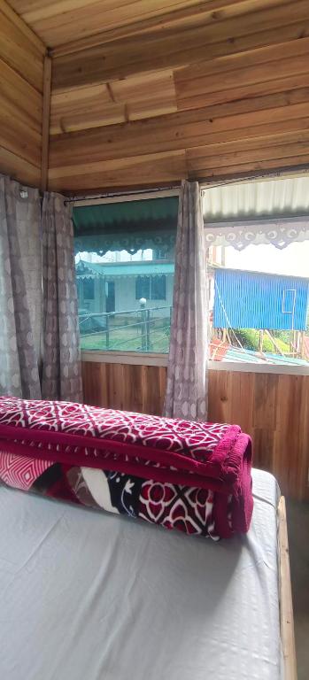 a bed in a room with a window at Zero Points TheLaure Cottage in Ilām