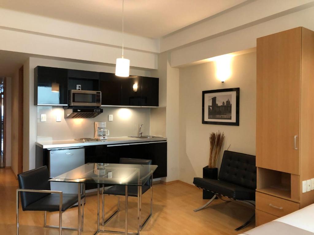 A studio-style living area combining the kitchenette, dining table and bed zone.