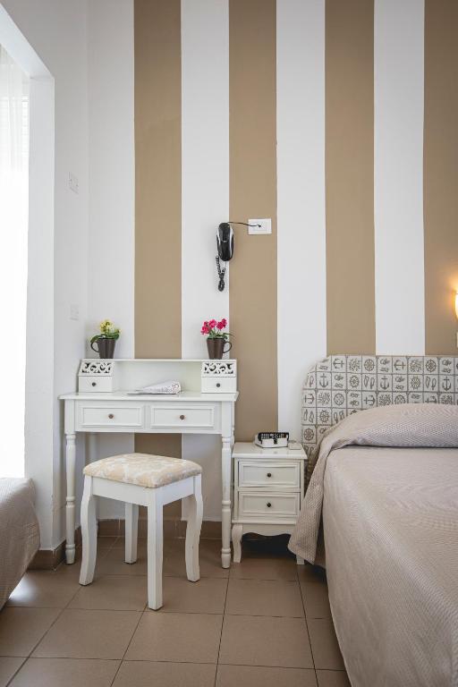 Postel nebo postele na pokoji v ubytování Hotel Ronchi