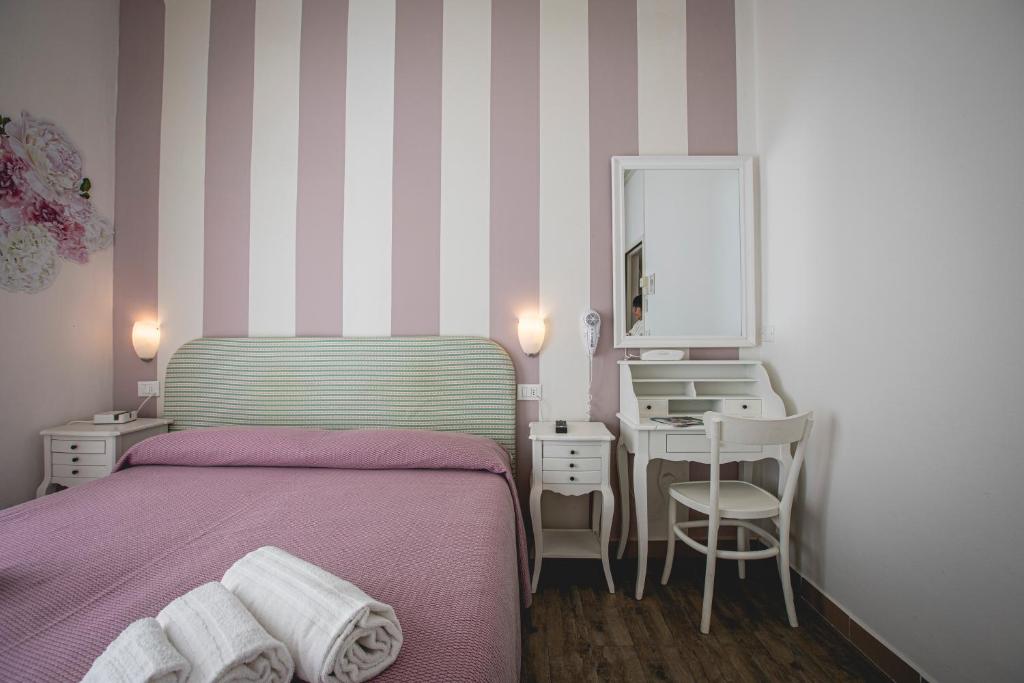 Postel nebo postele na pokoji v ubytování Hotel Ronchi