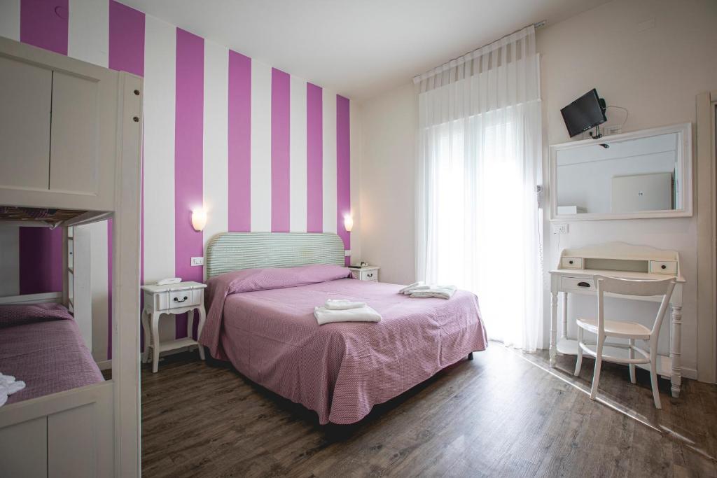 Postel nebo postele na pokoji v ubytování Hotel Ronchi
