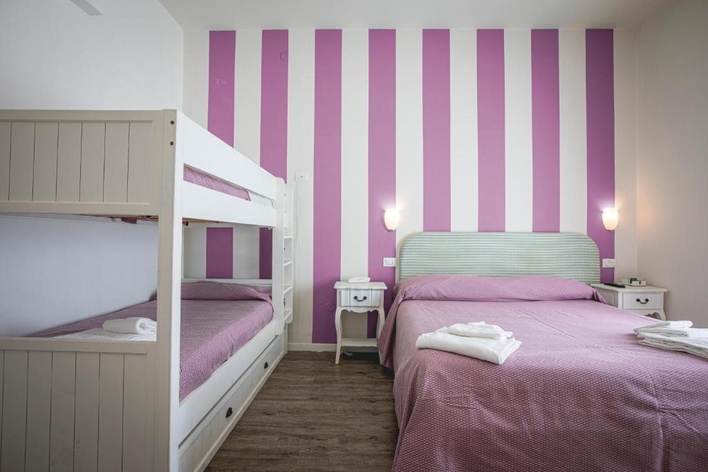 Postel nebo postele na pokoji v ubytování Hotel Ronchi