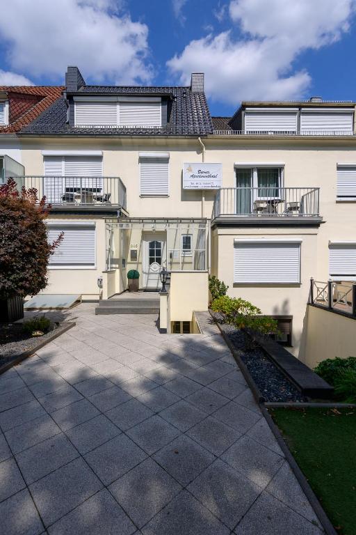 a large white building with a patio in front of it at Bremer Apartmenthotel Superior in Bremen