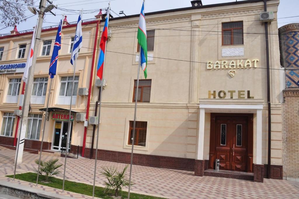 a building with flags in front of it at Гостевой дом Barakat in Samarkand