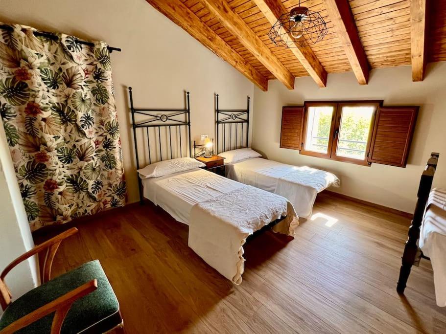 Postel nebo postele na pokoji v ubytování RAPIA Casa Rosa 1